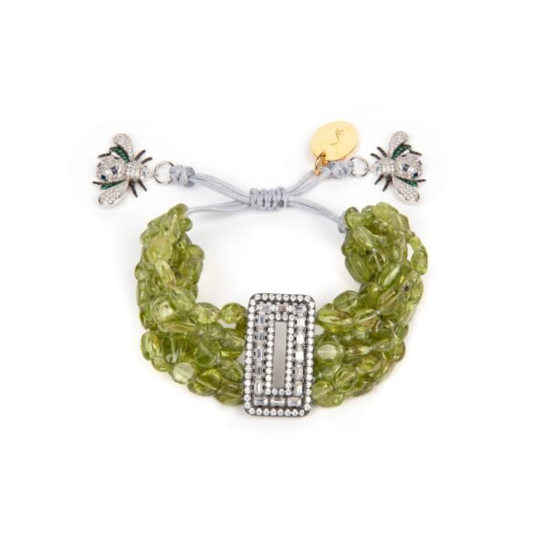 Multiple strings of glittering natural peridot gemstones cluster around a crystal encrusted angular centerpiece with a vintage finish in 925 sterling silver. Handmade and delicately tied